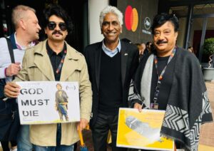 Ace Hollywood producer and former Tennis champion Ashok Amritraj unveils the poster of ‘God Must Die’ at the 77th Cannes Film Festival